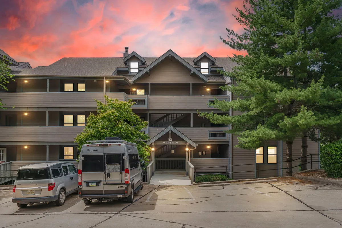 This image captures the exterior of the building, featuring a welcoming facade, accessible driveway, and convenient parking with surrounding greenery. The ground-level perspective visually supports the concept of step-free, walk-in access, essential for guests with mobility needs or strollers.